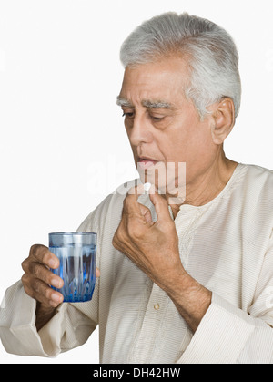 Close-up of a senior man taking medicine Stock Photo