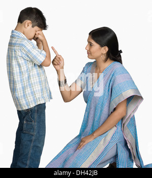 Side profile of a young woman scolding her son Stock Photo