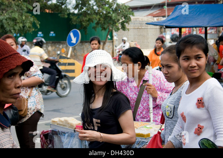 Women who work at a garment factory are leaving the compound after their shifts in Phnom Penh, Cambodia.