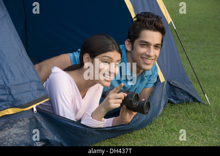 Couple lying in a tent and smiling Stock Photo
