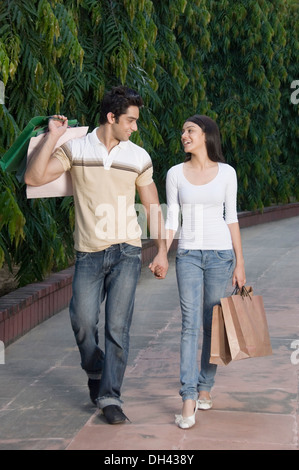 Couple carrying shopping bags and smiling Stock Photo