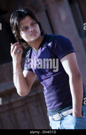 Man in blue jeans and violet purple Tshirt   MR#786 Stock Photo