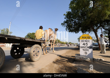 Camel Cart on road to Sanchor at Dharad village milestone Gujarat India Stock Photo