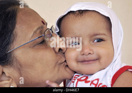 Indian Grandmother kissing granddaughter cheeks -    MR#736LA&364 - rmm 184970 Stock Photo