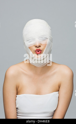 Woman's face wrapped with a bandage Stock Photo