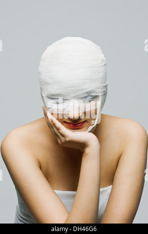 Woman's face wrapped with a bandage Stock Photo