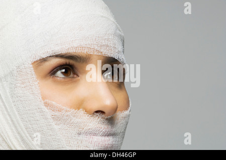 Woman's face wrapped with a bandage Stock Photo