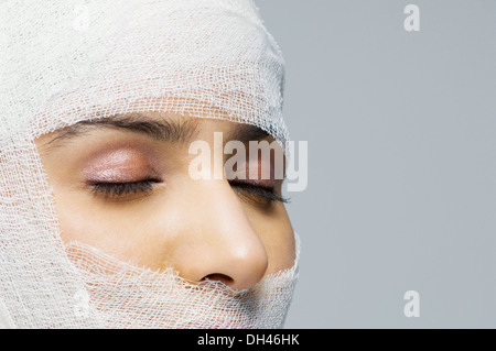 Woman's face wrapped with a bandage Stock Photo