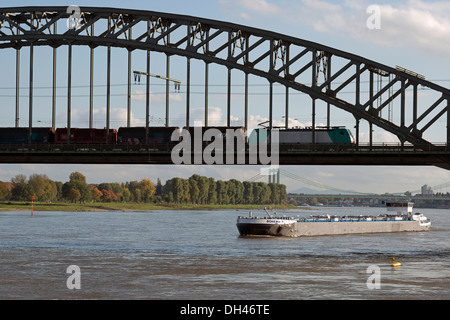 Freight train crossing the river Rhine, Cologne, Germany. Stock Photo