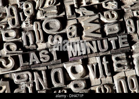 Old lead letters forming the words 'LAST MINUTE' Stock Photo