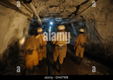 miners are walking through the tunnel at the underground coal mine in jharkhand India Stock Photo