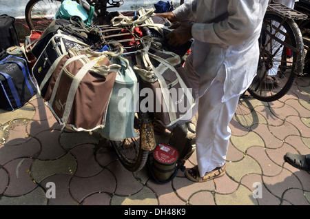 dabbawalas carrying lunchbox on cycle at mumbai maharashtra India Stock Photo