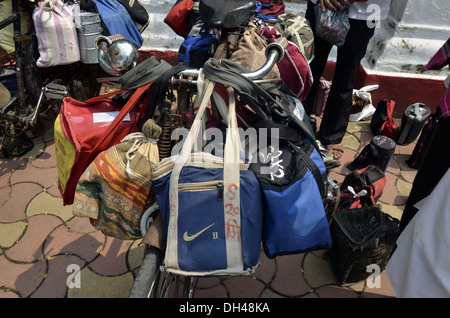 dabbawalas carrying lunchbox on cycle at mumbai maharashtra India Stock Photo