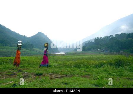 two tribal women carrying water pots at Papi Hills  Rajahmundry Andhra Pradesh India Stock Photo