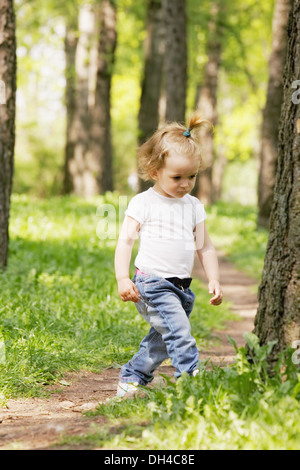 Little girl walking in park Stock Photo