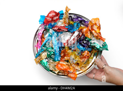 A tin lid of empty sweet wrappers (Roses chocolates) Stock Photo