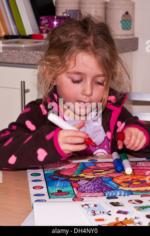 5 Year Old Girl Colouring A Picture In A Colouring Book Stock Photo
