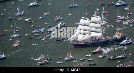 The Netherlands, Amsterdam, sailing event SAIL. Aerial of parade of tall ships. Big sailing boat called Clipper Stad Amsterdam. Noordzeekanaal. Stock Photo