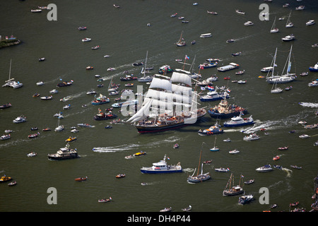 The Netherlands, Amsterdam, sailing event SAIL. Aerial of parade of tall ships. Big sailing boat called Clipper Stad Amsterdam. Noordzeekanaal. Stock Photo