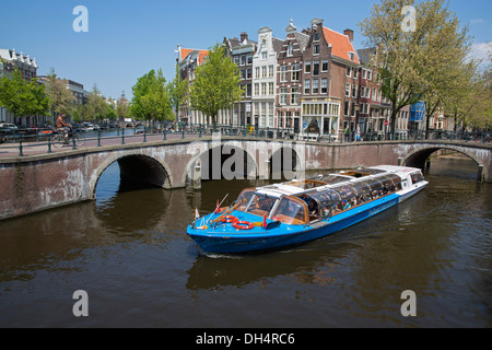 Netherlands, Amsterdam, Crossing of canals called Keizersgracht and Leidsegracht. UNESCO World heritage Site. Roundtrip boat. Canal or tour boat.
