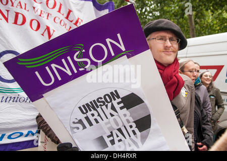 London, UK. 31st October 2013. A protester with his placard as striking staff, students and the unions Unison, Unite and UCU combined with pickets and a march to demand fairer wage increases and a living wage for low-paid university support staff. Credit:  Paul Davey/Alamy Live News