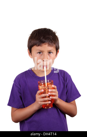 Young boy drinking from orange glass on white background Stock Photo