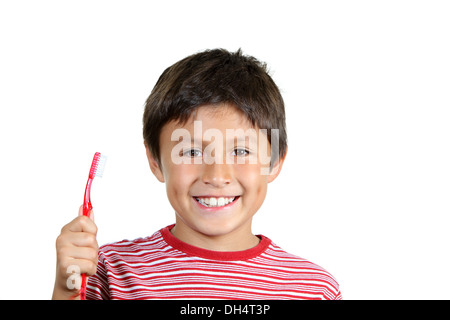 Young boy brushing teeth on white background Stock Photo