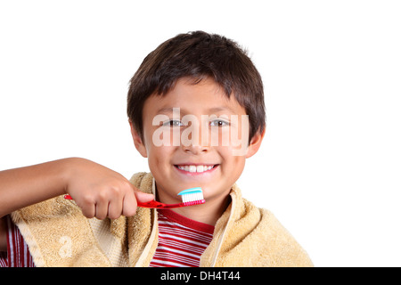 Young boy brushing teeth on white background Stock Photo