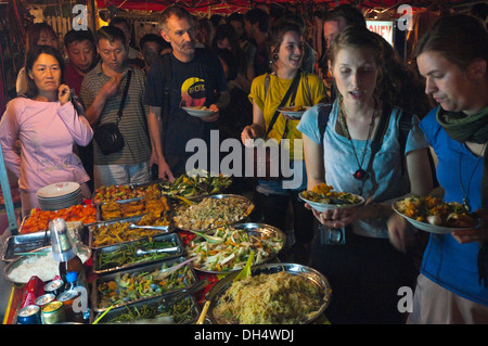 Horizontal close up of a busy 'all you can eat' buffet at night in Laos. Stock Photo