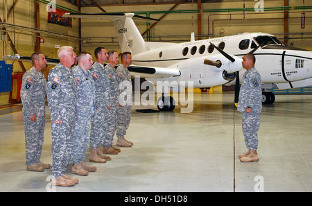 Soldiers assigned to the New York Army National Guard's Detachment 20, Operation Support Airlift Agency stand in formation on Fr Stock Photo