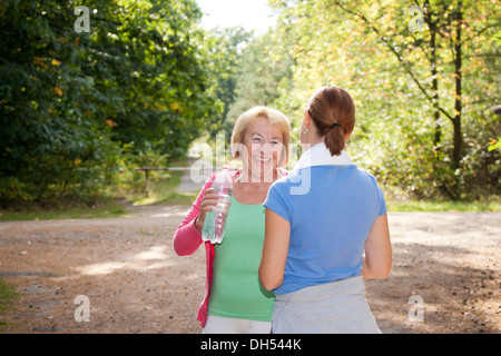 Women taking a break while doing sports outdoors Stock Photo