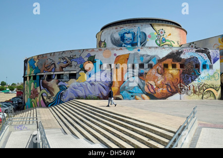 Street art by Spanish artist El Niño de las Pinturas (aka Raul Ruiz) on the rear of the bus station at Seville, Andalusia, Spain. Stock Photo