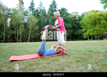 Women doing gymnastics outdoors Stock Photo