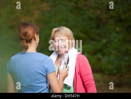 Women taking a break while doing sports outdoors Stock Photo