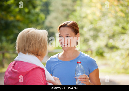 Women taking a break while doing sports outdoors Stock Photo