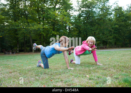 Women doing gymnastics outdoors Stock Photo