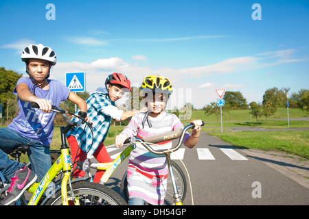 Children wearing bike helmets at a traffic awareness course Stock Photo