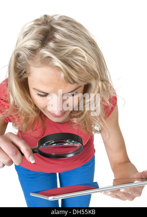 woman with magnifying glass and tablet pc Stock Photo