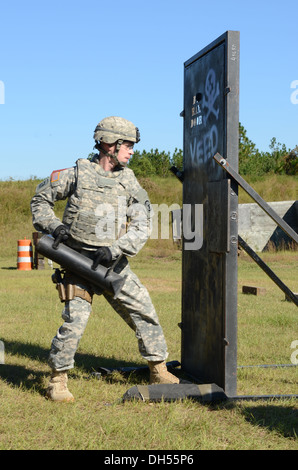 Sgt. Zachery M. Pryor of Litchfield, Ill. breeches a door as part of the challenge trying out for a position on the Fort Bragg Special Reaction Team here Oct. 24, 2013. The challenge includes an Army physical fitness test, an obstacle course, an obstacle Stock Photo
