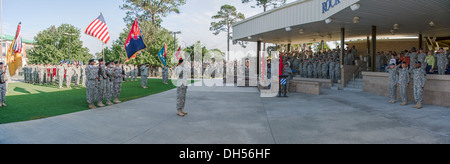 Soldiers salute and civilians place their hands over their hearts as the national anthem is played during a change of responsibility ceremony here at Marne Garden, Oct. 25. Command Sgt. Maj. Jefferson Moser, a native of Dearborn, Mich., and the outgoing s Stock Photo