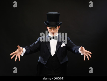 magician in top hat showing trick Stock Photo