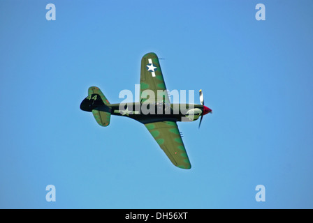P-40 Curtiss Kittyhawk Flying Against Clear Blue Sky at Sywell Piston and Props Show Stock Photo