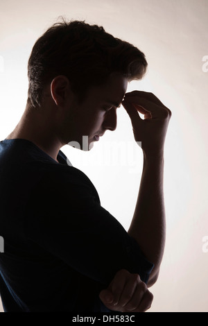 Pensive young man, backlit, Mannheim, Baden-Württemberg, Germany Stock Photo