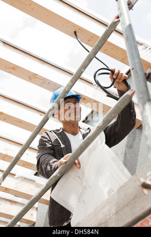 Construction manager controlling the electrical wiring on a construction site, Mannheim, Baden-Württemberg, Germany Stock Photo