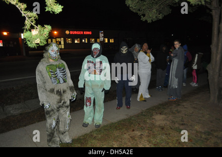 Soldiers from 70th Brigade Support Battalion, 210th Fires Brigade, 2nd Infantry Division, show off their Halloween costumes before beginning a battalion Halloween fun run. This run focused on building unit cohesion and morale throughout the unit. Stock Photo