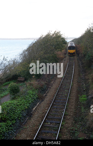 A train leaves st. ives station in cornwall and travels along the coast line by porthminster beach Stock Photo