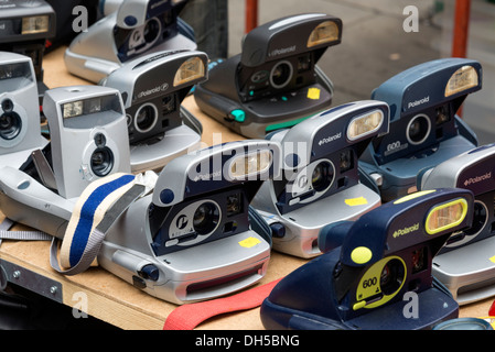 Old Polaroid cameras on stall in Brick Lane market, London, UK Stock Photo