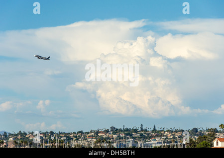 A plane passing in front of thunderclouds. San Diego, California, United States. Stock Photo