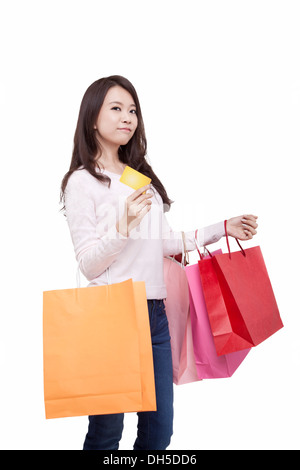 Oriental young woman holding shopping bags Stock Photo