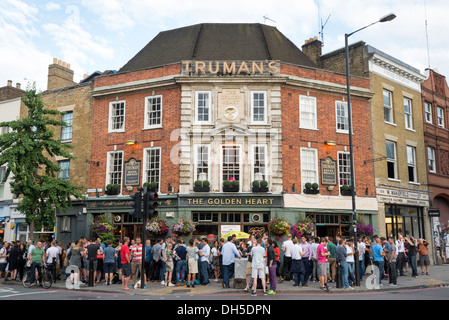 People drinking outside The Golden Heart pub in Spitalfields, London, England, UK Stock Photo